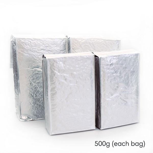 Three silver foil bags on a white background with text indicating weight.